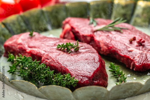 Pieces of cooked rump steak with spices served on old meat tray. Steak of marbled beef black Angus. Raw beef ramp steak, top view