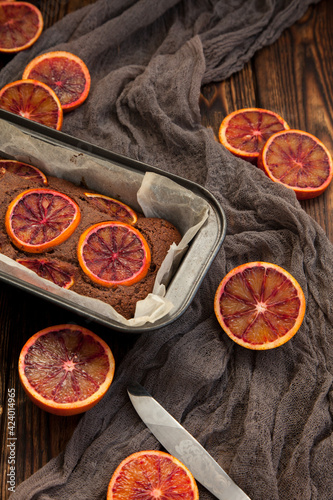 Delicious cupcake with red oranges from the oven in a baking dish on a wooden table,copy space.