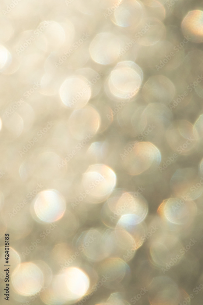 bright glitter background: bokeh effect from many colored lights on frozen glass, toning