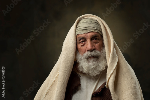 Portrait of old bearded man with ancient attire