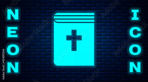 Glowing neon Holy bible book icon isolated on brick wall background. Vector