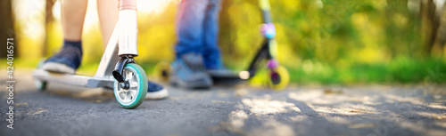 Boyfriends riding on bicycles on asphalt road in summer.