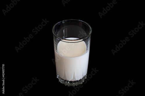 a glass of milk on a black background