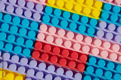 children s play background  the plane of plastic multi-colored bricks  blur  selective focus