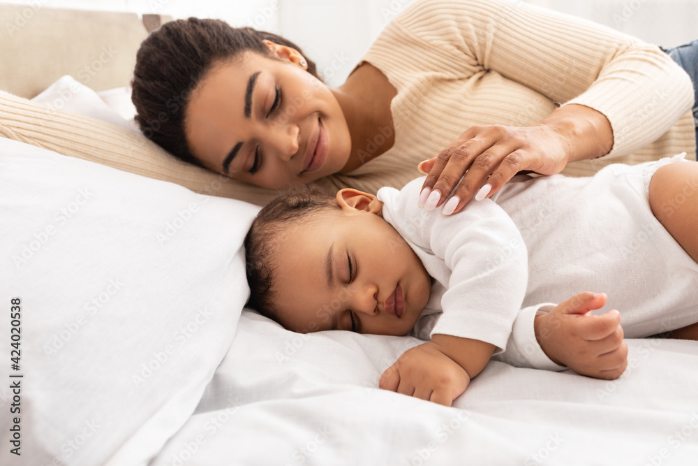 Loving Black Mom Hugging Sleeping Baby Lying In Bed Indoor Loving Black Mom Hugging Sleeping Baby Lying In Bed Indoor