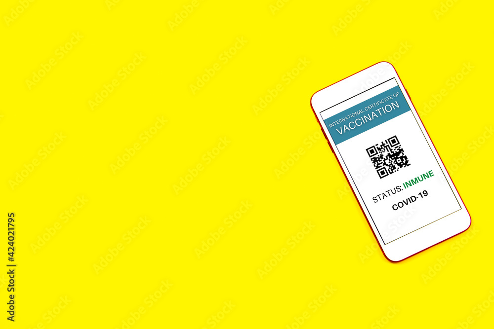 Yellow background with a smartphone with the certificate of vaccination against Covid-19. Yellow background with a smartphone with the certificate of vaccination against Covid-19.