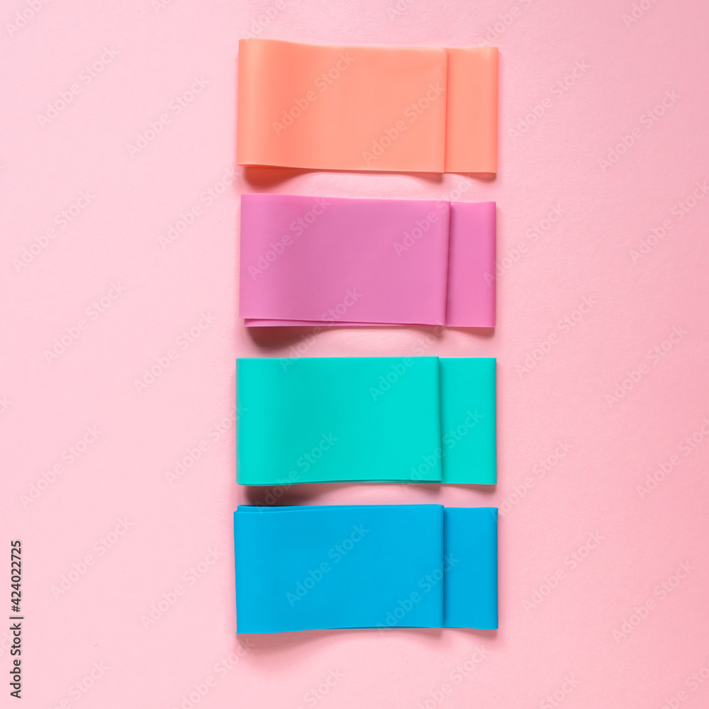 Elastic resistance bands on the pink background. Fitness equipment, accessories. Elastic resistance bands on the pink background. Fitness equipment, accessories.