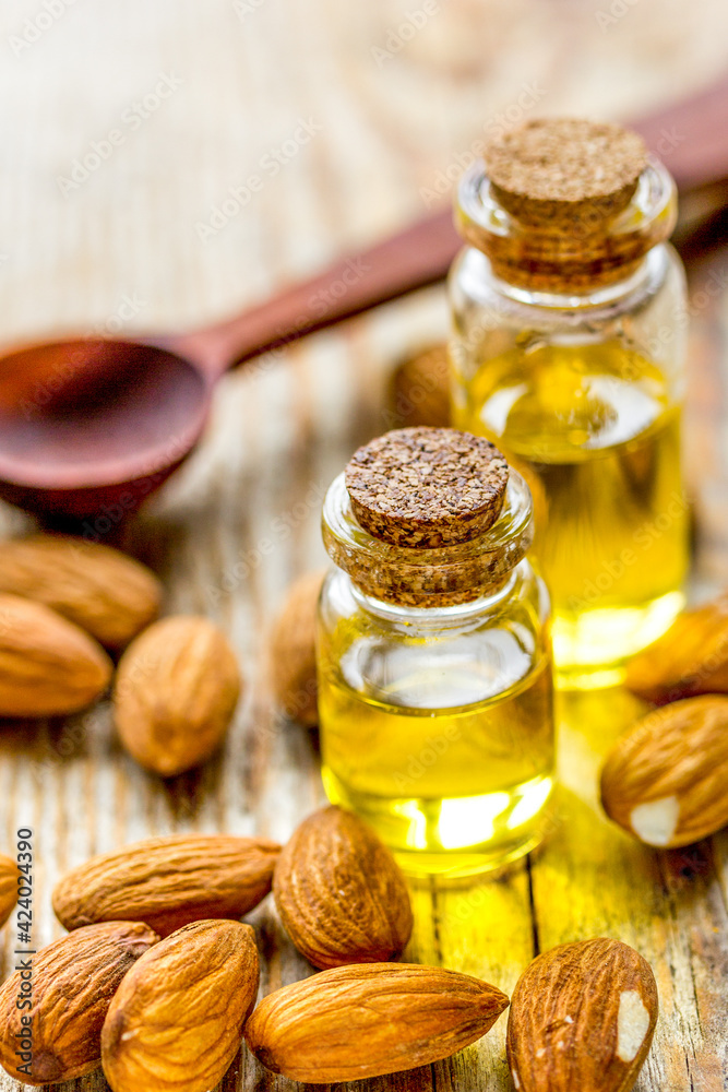 spa with almond oil in organic cosmetic set on wooden background spa with almond oil in organic cosmetic set on wooden background