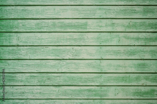 old worn green planks stacked side by side