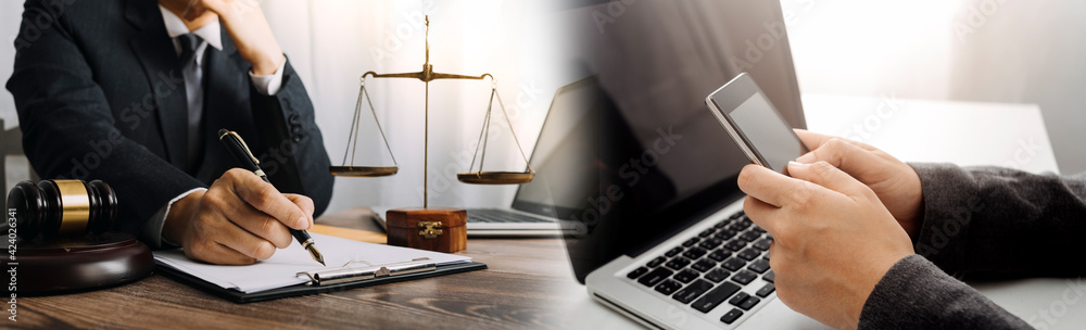 Business and lawyers discussing contract papers with brass scale on desk in office. Law, legal services, advice, justice and law concept picture with film grain effect Business and lawyers discussing contract papers with brass scale on desk in office. Law, legal services, advice, justice and law concept picture with film grain effect