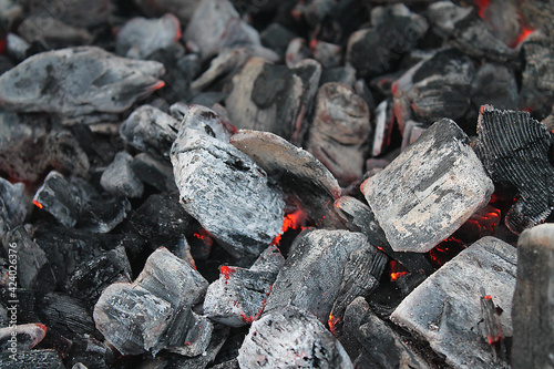 A smoldering pile of coal in the ashes