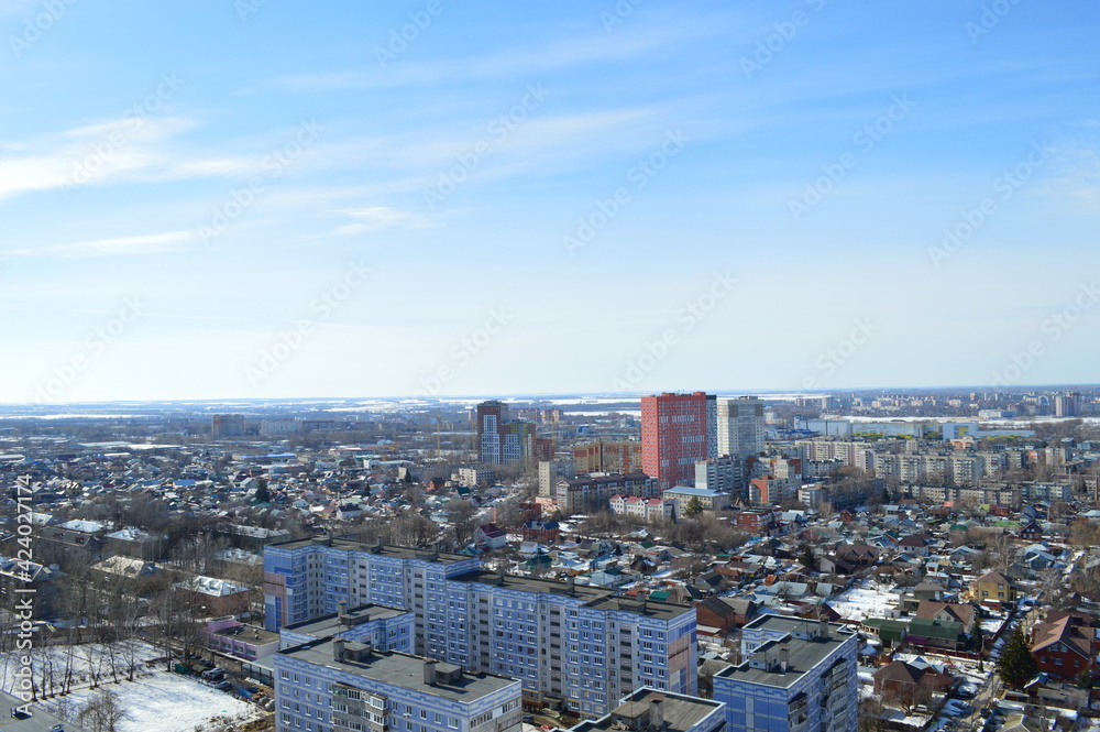 view of the city and multi-storey and one-storey buildings on a sunny day