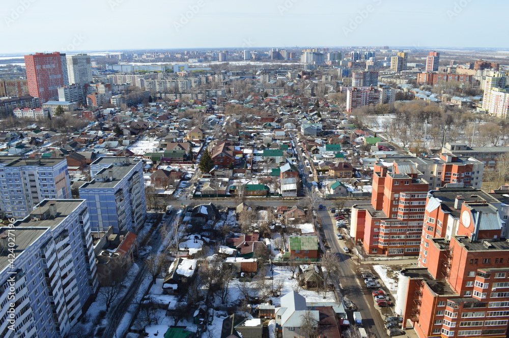 Fototapeta premium view of the city and multi-storey and one-storey buildings on a sunny day