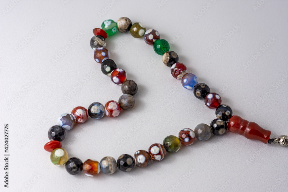 Colorful men's Muslim Prayer beads heart shape on white background Colorful men's Muslim Prayer beads heart shape on white background