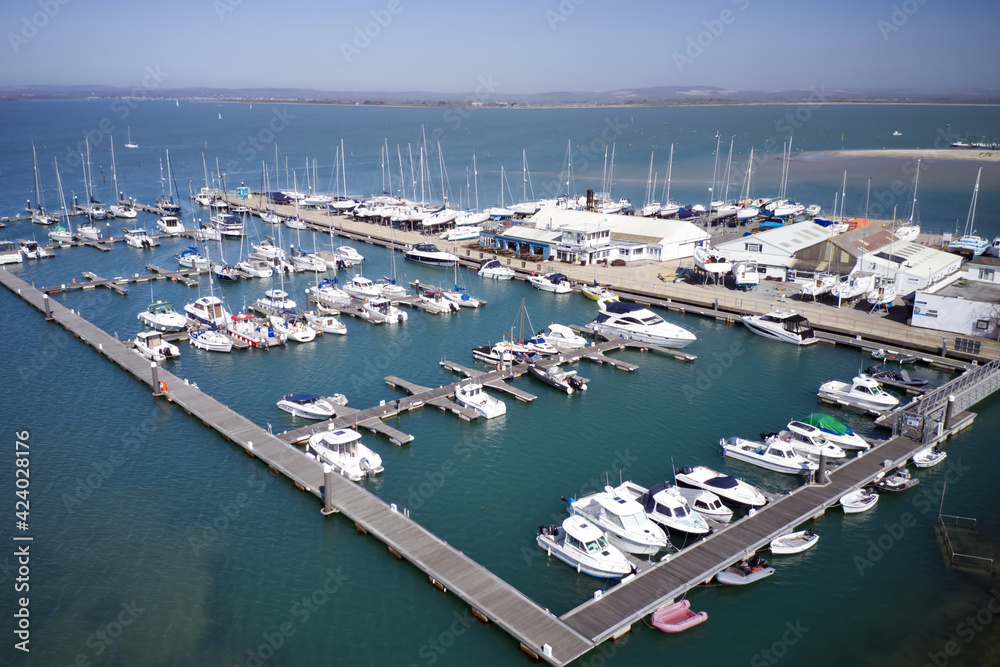 Sparkes Marina full of moored yachts and boats situated on Hayling Island east shoreline on the estuary, Aerial Photo.