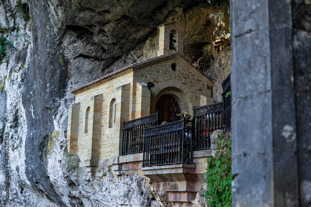 Detail of La Santina, a small chapel inside a cave. Photograph taken in the Picos de Europa, Asturias, Spain. 
