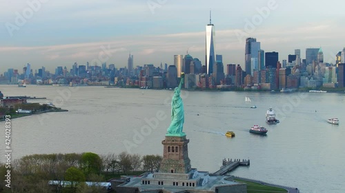 Aerial view of the Statue of Liberty at sunset. Manhattan and New Jersey skyline in the background. New York City, United States.