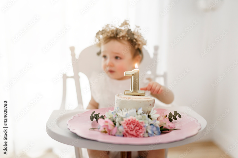 First birthday cake of a baby girl sit on chair First birthday cake of a baby girl sit on chair