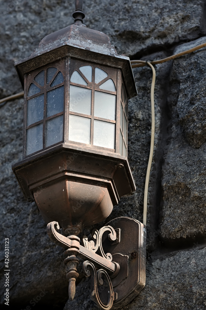 Small old street lantern on the wall in Kyiv Ukraine