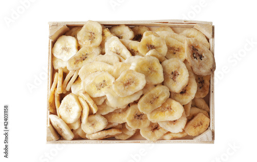 Wooden bowl with sweet banana slices on white background, top view. Dried fruit as healthy snack