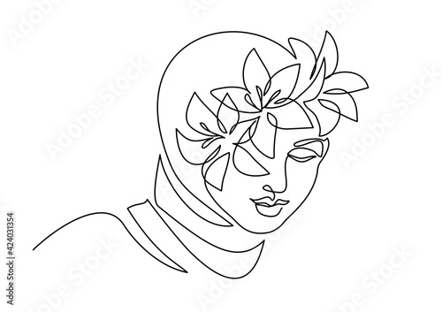 Young happy woman in hijab with flowers on her face