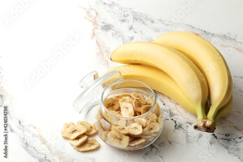 Composition with sweet banana slices   , top view with space for text. Dried fruit as healthy snack. Healthy breakfast