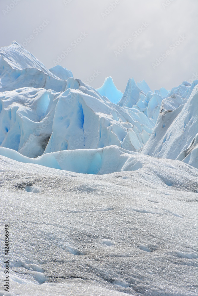 Large and thick mass of ice formed in successive layers of compacted and recrystallized snow. Large and thick mass of ice formed in successive layers of compacted and recrystallized snow.