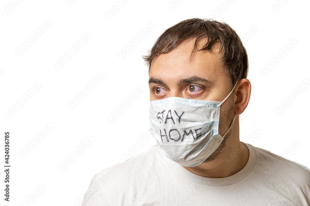 white male in a white protective medical mask. Mask lettering white male in a white protective medical mask. Mask lettering