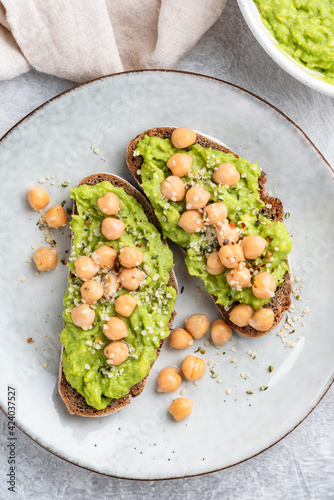 Vegan toasts with avocado and chickpeas top view