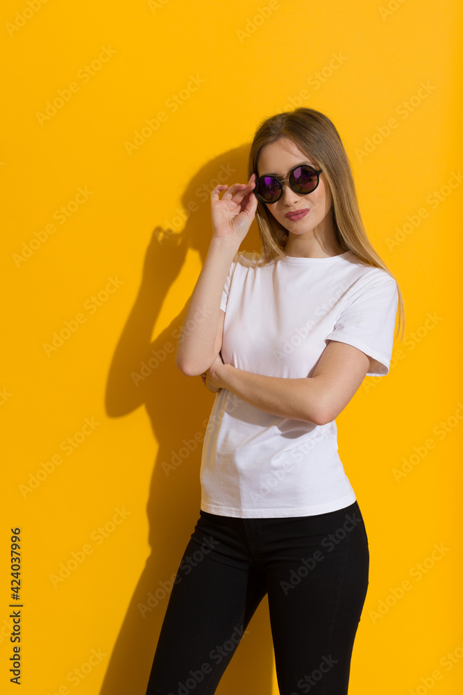 Portrait Of Young Blond Woman In Sunglasses And White Shirt
