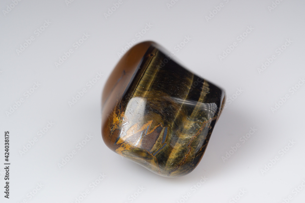 Natural gem tiger's eye on a white background Natural gem tiger's eye on a white background