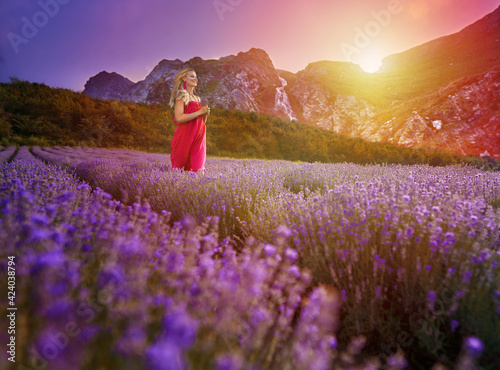 Woman running through a lavender field with mountains behind © Xalanx