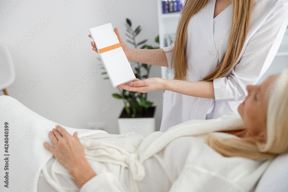 Φωτογραφία Photo of senior woman in white bathrobe laying on daybed and checking results of