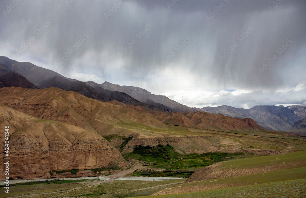 Thundercloud and heavy rain over the mountains and river valley. Stock ...