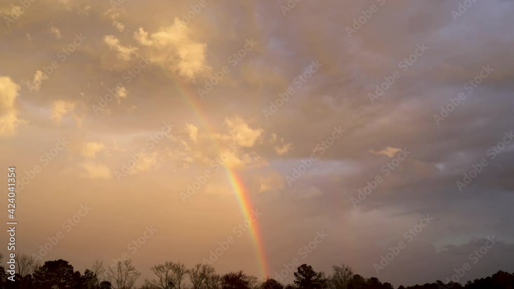 Rapid weather changes, double rainbows appearing on sky, time lapse Rapid weather changes, double rainbows appearing on sky, time lapse