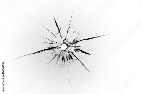 The texture of cracks from a bullet on the glass. Abstraction of shot glass for design