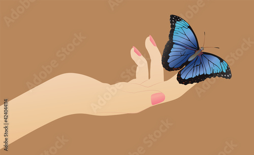 butterfly on a female hand on a beige background
