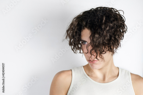 Side view of a teenage boy with long hair that covers almost the entire face visible to only one eye. Dramatic portrait of a teenage boy © Мар'ян Філь