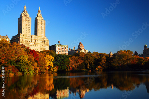 The luxury apartment buildings of Manhattan rise over the autumn foliage of Central Park © kirkikis