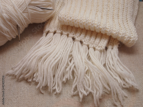 white hand-knitted scarf on canvas