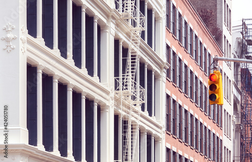 Old building with iron fire escape, color  toning applied, New York City, USA.
