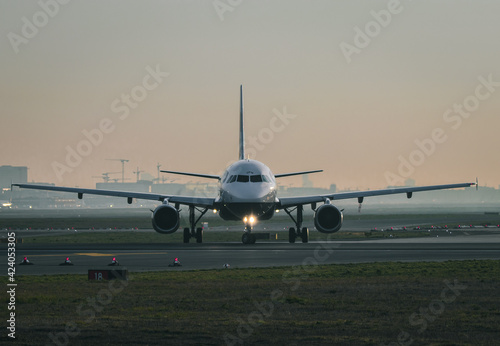 Frankfurt, Hesse, Germany, 07.04.2019: frontal image of a commercial passenger airplane on a taxiway during sunrise. 