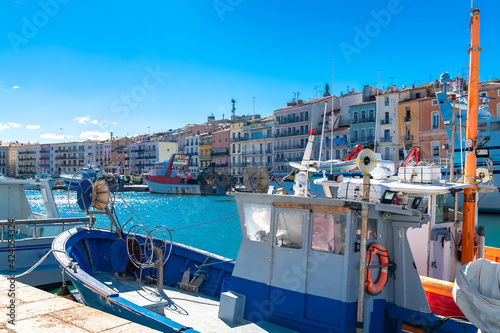 Sète in France, fisherboat at the quay, typical colorful facades.
