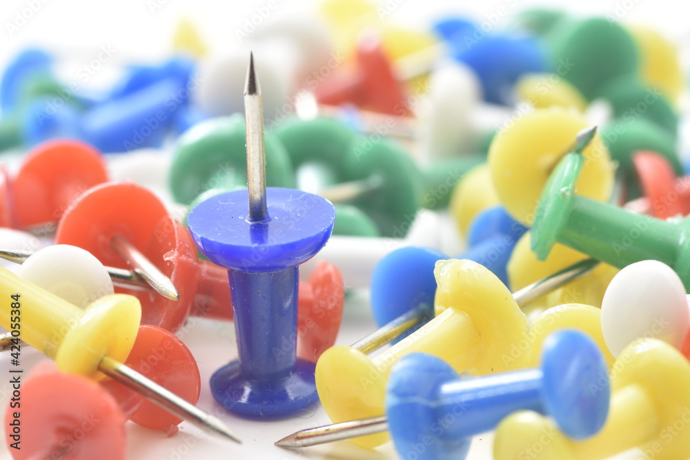 a lot of colorful pushpin close up on white background. a lot of colorful pushpin close up on white background.