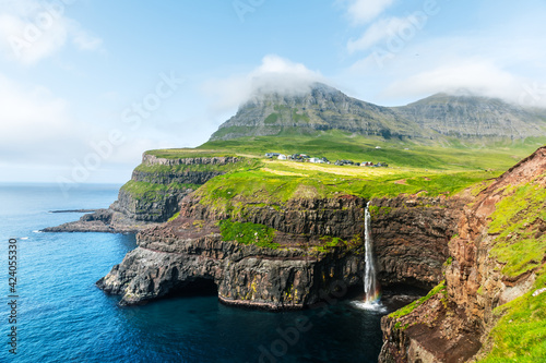 Incredible day view of Mulafossur waterfall in Gasadalur village, Vagar Island of the Faroe Islands, Denmark. Landscape photography
