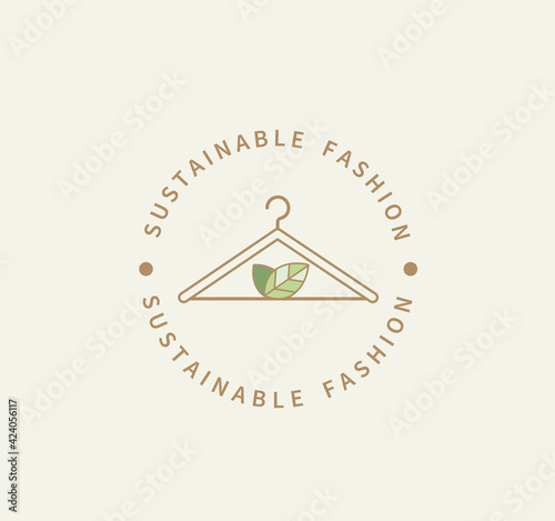 Sustainable fashion logo.Eco friendly production.Label,icon badge with clothes hanger and green leaves for natural recycling clothing,ethical fabric and slow fashion with sustainable materials.Vector