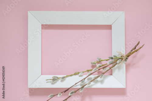 delicate pink spring background with pussy willow branches, and a white frame for the picture, Happy Easter background