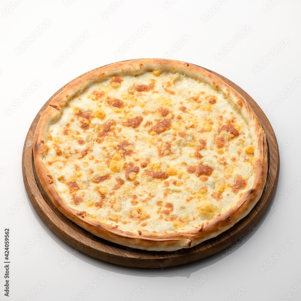 Whole cheese pizza on wooden round cutting board on white background. Classic italian food. Nutrition dinner or lunch. Square format for online food delivery. Whole cheese pizza on wooden round cutting board on white background. Classic italian food. Nutrition dinner or lunch. Square format for online food delivery.