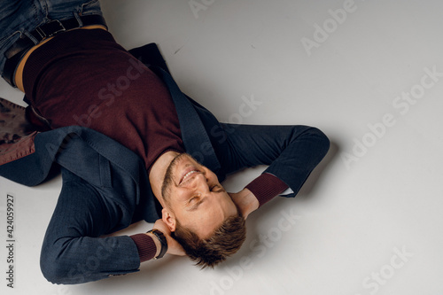 Fashion business man model posing in the studio. Confident male weared casual suit.