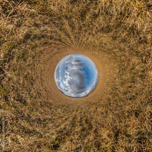 blue sky ball in middle of swirling field. Inversion of tiny planet transformation of spherical panorama 360 degrees. Curvature of space.